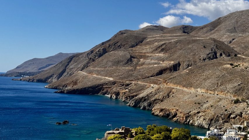 Driving along a challenging coastal road in Crete with rental car