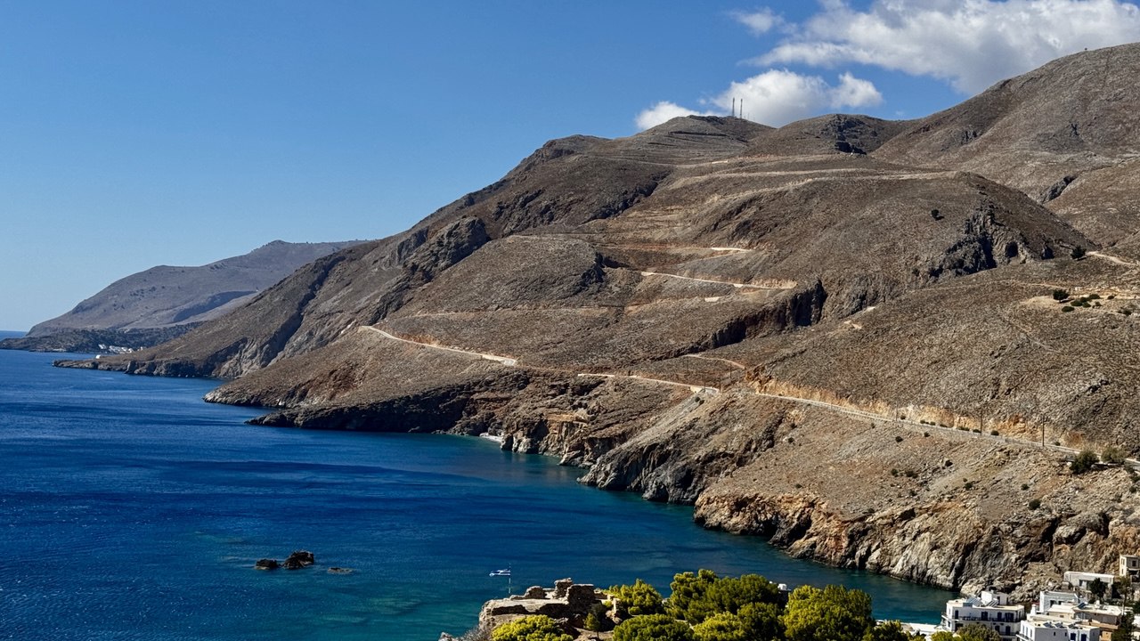Driving along a challenging coastal road in Crete with rental car